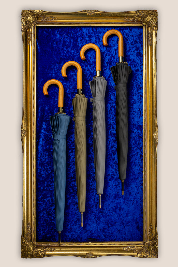 Joseph Blue men’s windproof umbrella with wooden J-handle, blending classic design with reliable durability for refined all-weather protection.