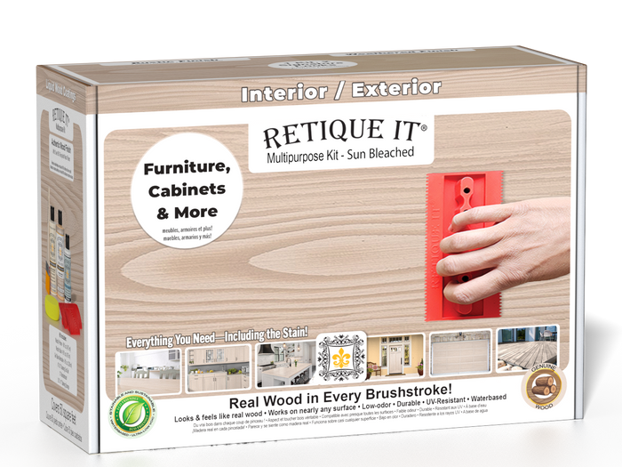 Sun-bleached Retique It Wood'n Finish Kit in an open box with brushes and wood samples, designed for multi-purpose wood finishing.