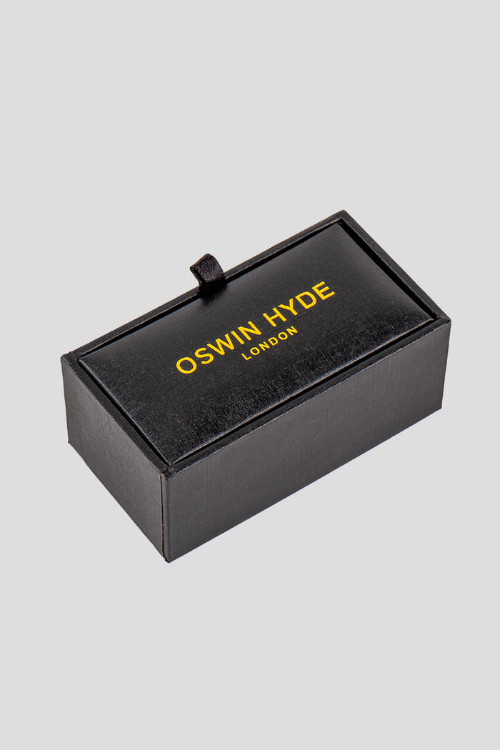 Square black men’s cufflinks featuring deep black enamel set in polished metal with intricate detailing for precise, formal elegance.