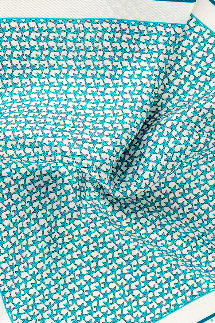 Blue silk pocket square handkerchief with a blue star print and four versatile folds, ideal for wedding, business or refined casual wear.