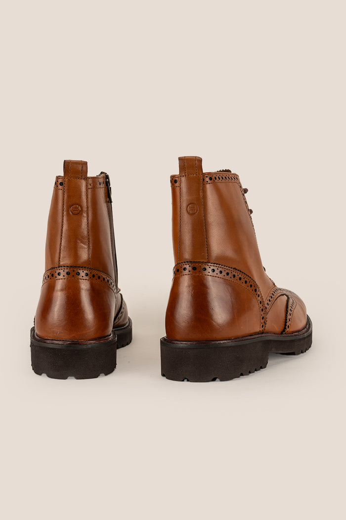 Graham tan leather brogue boots for men with classic perforated detailing, ideal for dressy and smart-casual occasions.