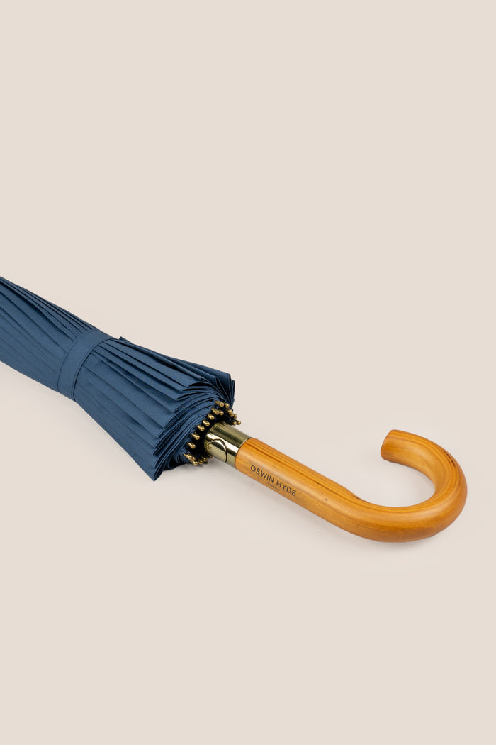 Joseph Blue men’s windproof umbrella with wooden J-handle, blending classic design with reliable durability for refined all-weather protection.