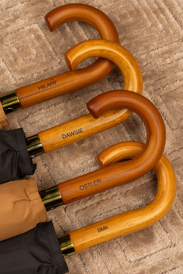 Joseph Blue men’s windproof umbrella with wooden J-handle, blending classic design with reliable durability for refined all-weather protection.