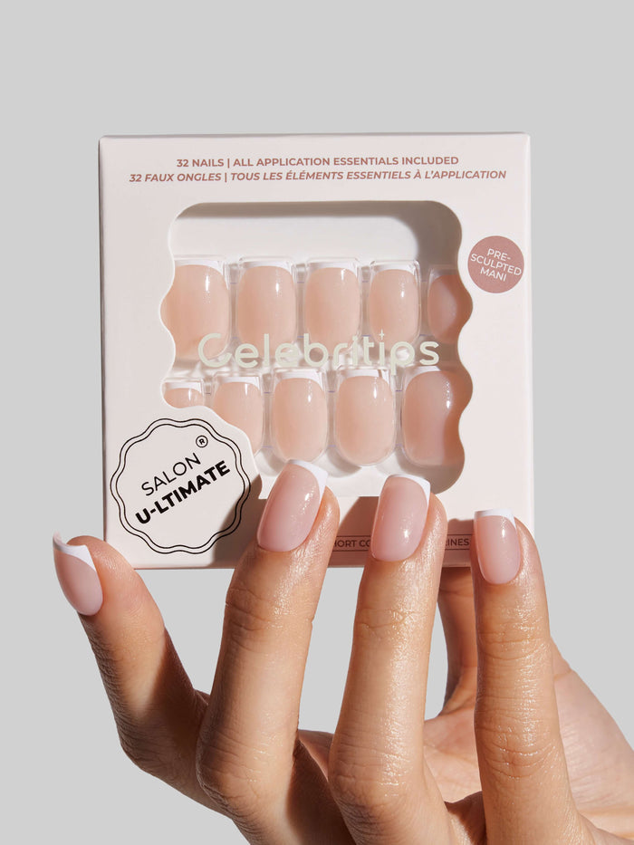 Packaged press-on nails with a hand displaying nails painted in a matching color against a light gray background