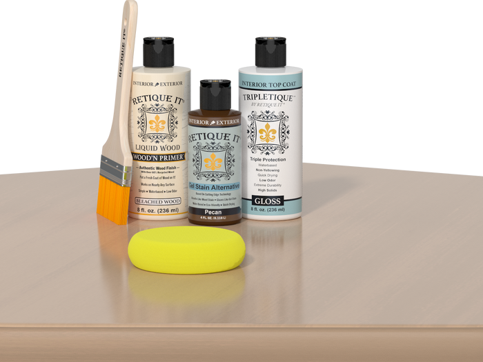 Retique It® White Oak kit with brush, Wood’n Primer, Pecan stain alternative, gloss top coat, and yellow sponge on a wood surface.