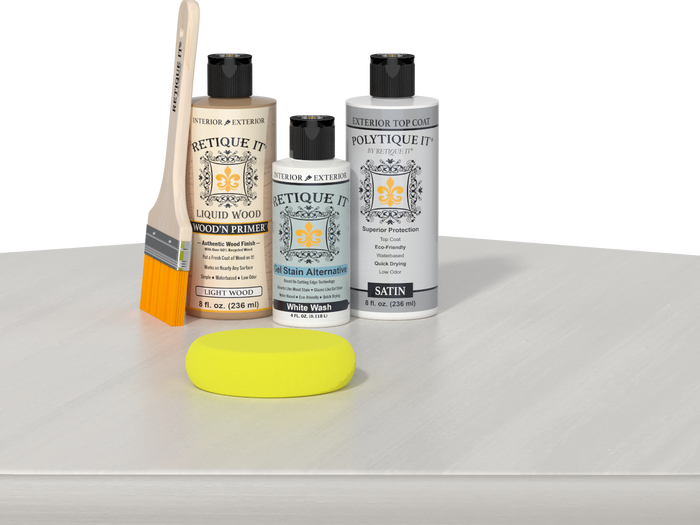 Retique It® Light Wood Wood’n Primer with White Wash Gel Stain Alternative, satin topcoat, brush, and yellow sponge on a white tabletop.