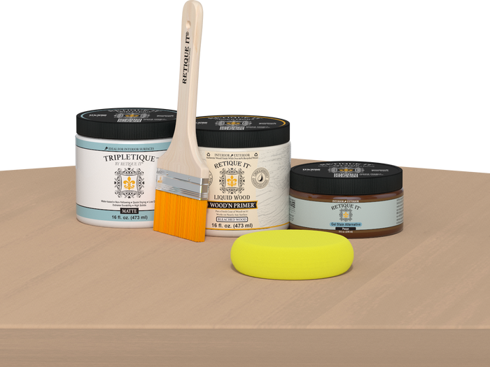 Retique It® Pecan Multipurpose Kit contents with Bleached Wood Liquid Wood primer, Pecan gel stain alternative, Tripletique matte interior top coat, paintbrush, and yellow sponge displayed on a light wood surface.