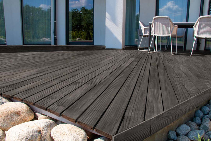 Retique It Wood'n Finish Kit in Harbor Gray showing textured exterior wood decking with gray top coat finish.