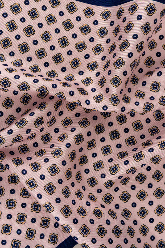 Salmon silk pocket square for men with intricate geometric pattern, crafted from luxurious silk for formal and smart-casual occasions.
