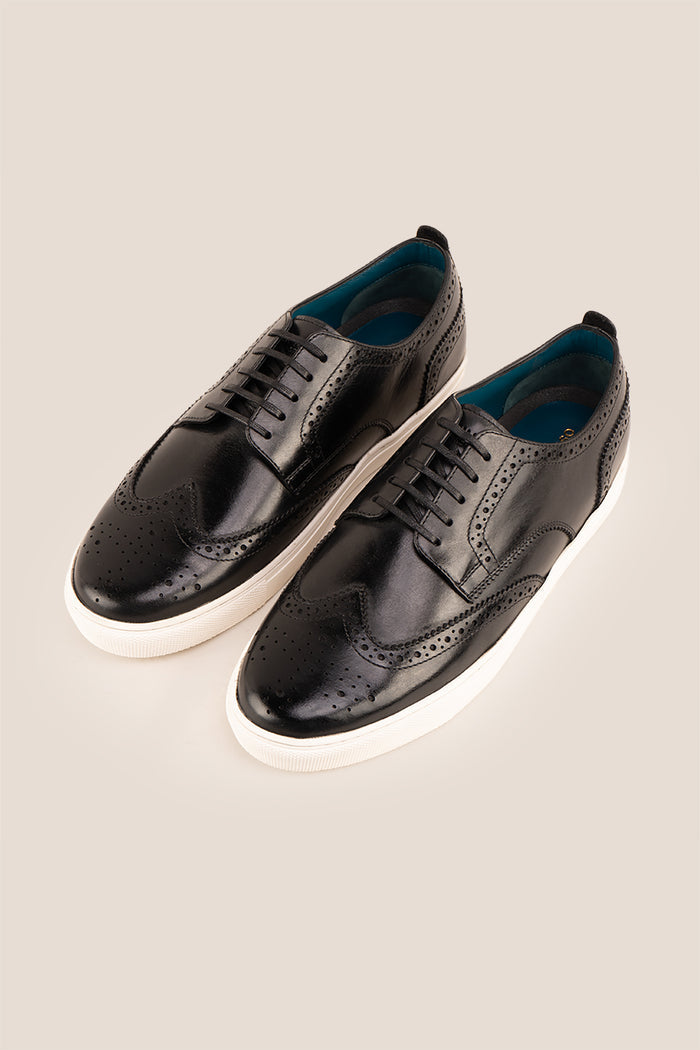 Stan Black wingtip brogue trainer shoes for men, crafted from premium leather with classic wingtip detailing and modern trainer sole.
