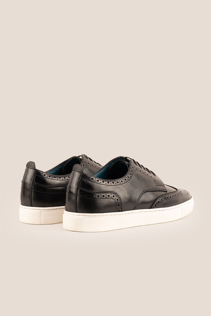 Stan Black wingtip brogue trainer shoes for men, crafted from premium leather with classic wingtip detailing and modern trainer sole.