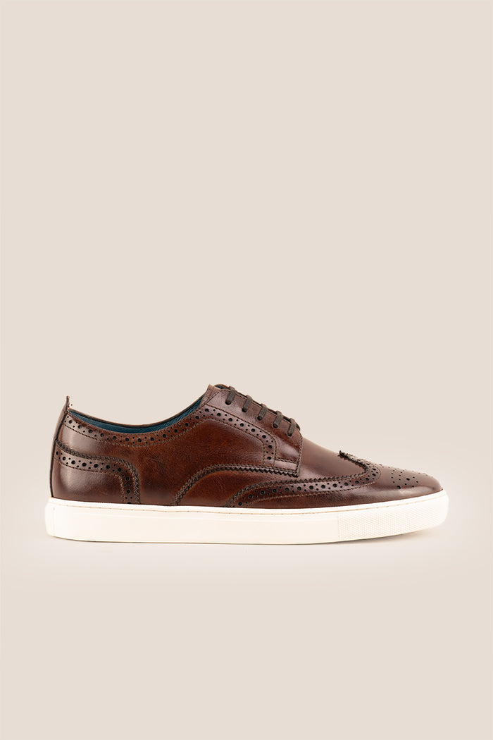 Stan Brown wingtip brogue trainer shoes for men, crafted from premium leather with classic wingtip detailing and modern trainer sole.