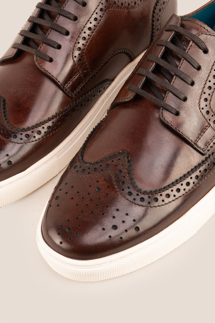 Stan Brown wingtip brogue trainer shoes for men, crafted from premium leather with classic wingtip detailing and modern trainer sole.