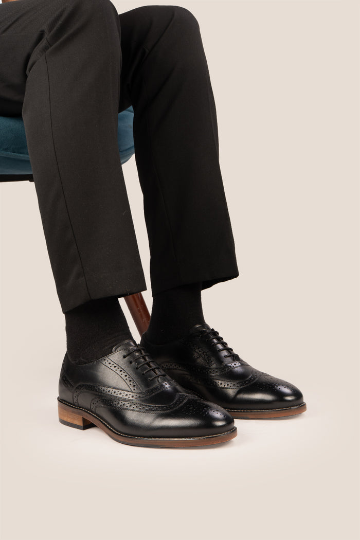 Experience comfort and style with the Winston Black Wide Fit brogue. Premium leather, classic brogue detailing, and extra room for all-day wear.