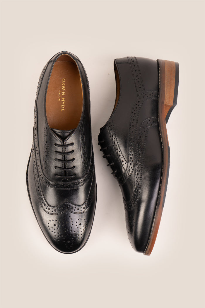 Experience comfort and style with the Winston Black Wide Fit brogue. Premium leather, classic brogue detailing, and extra room for all-day wear.