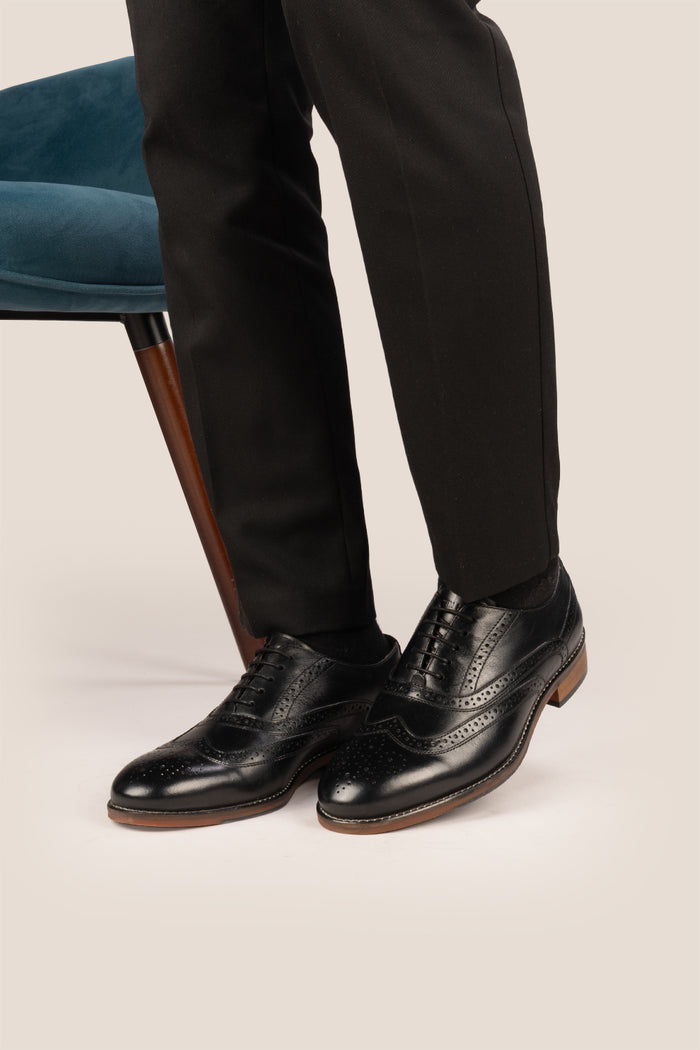Experience comfort and style with the Winston Black Wide Fit brogue. Premium leather, classic brogue detailing, and extra room for all-day wear.