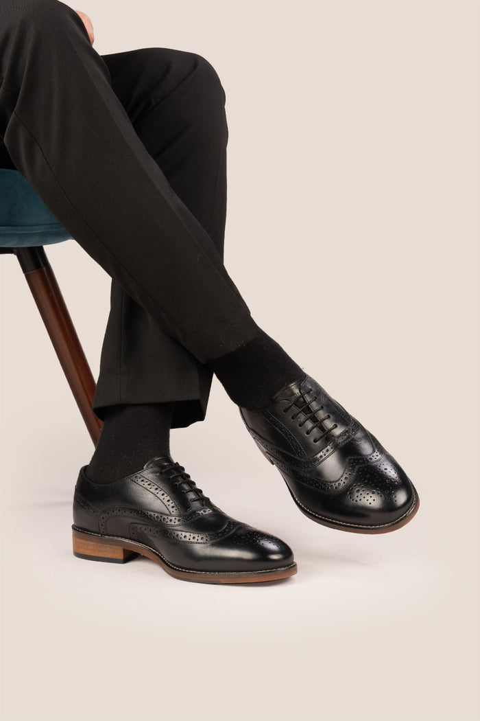 Experience comfort and style with the Winston Black Wide Fit brogue. Premium leather, classic brogue detailing, and extra room for all-day wear.