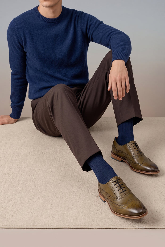 Model wearing Winston men’s Oxford brogue shoes in green leather with wingtip detail, perforated accents, and a classic lace-up silhouette—crafted for formal distinction.