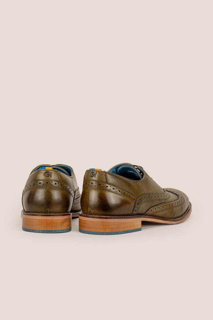 Winston men’s Oxford brogue shoes in green leather with wingtip detail, perforated accents, and a classic lace-up silhouette—crafted for formal distinction.