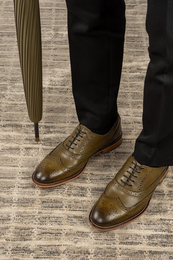 Winston men’s Oxford brogue shoes in green leather with wingtip detail, perforated accents, and a classic lace-up silhouette—crafted for formal distinction.
